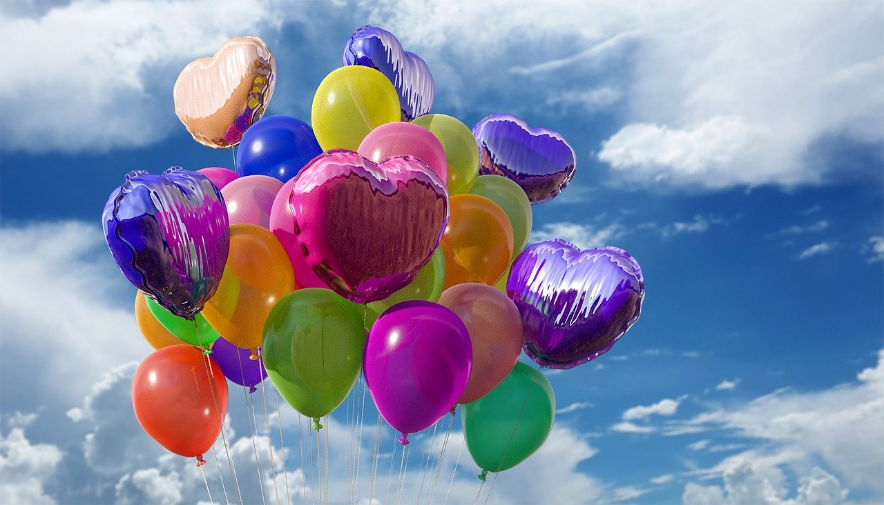 Helium filled balloons floating in the sky