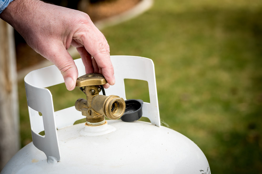 Opening a valve on a propane tank